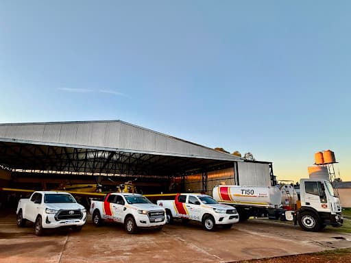 A professional aviation maintenance hangar with technicians working on an aircraft propeller.
